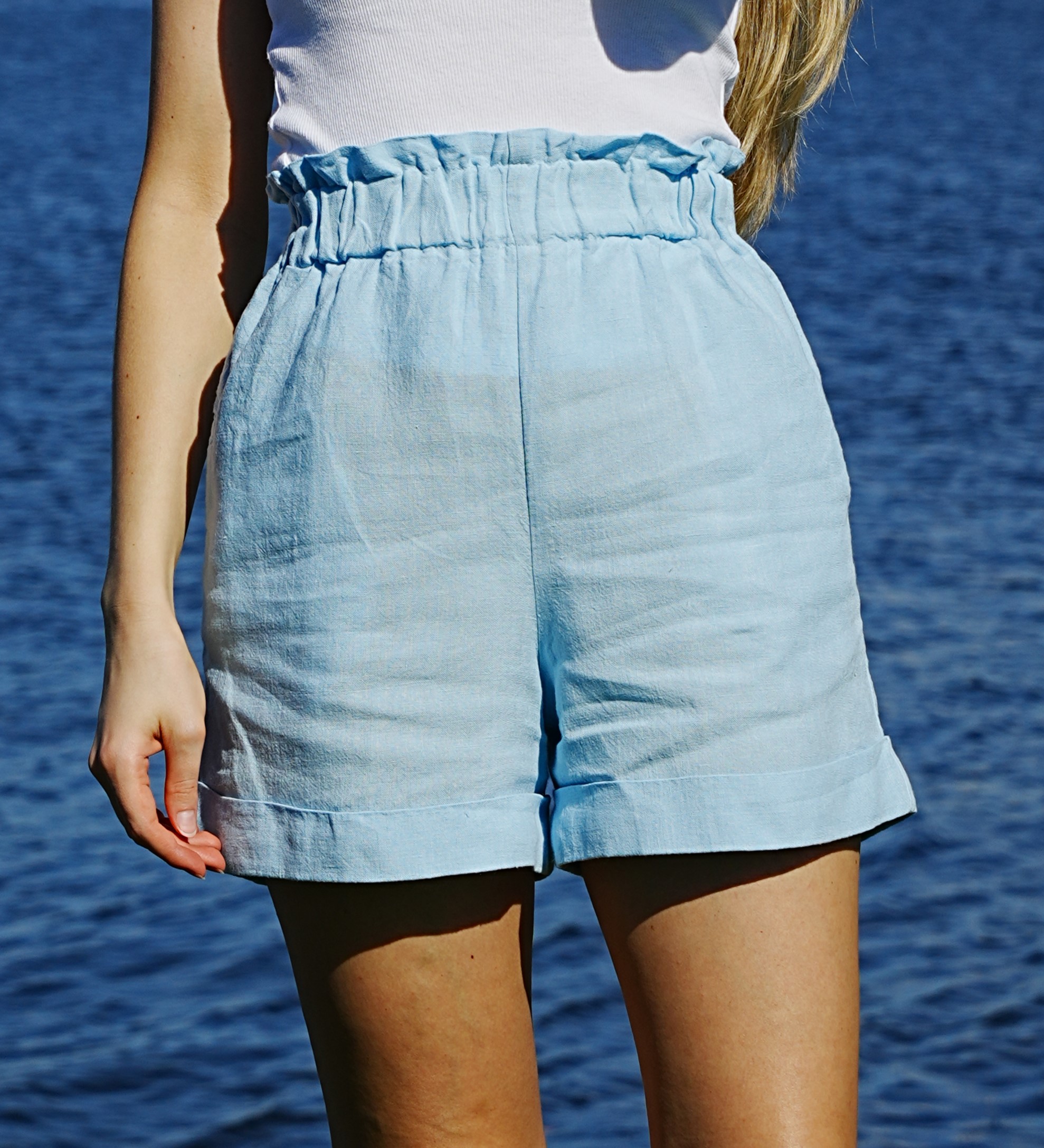 Capri Shorts — paper-bag waist by the sea