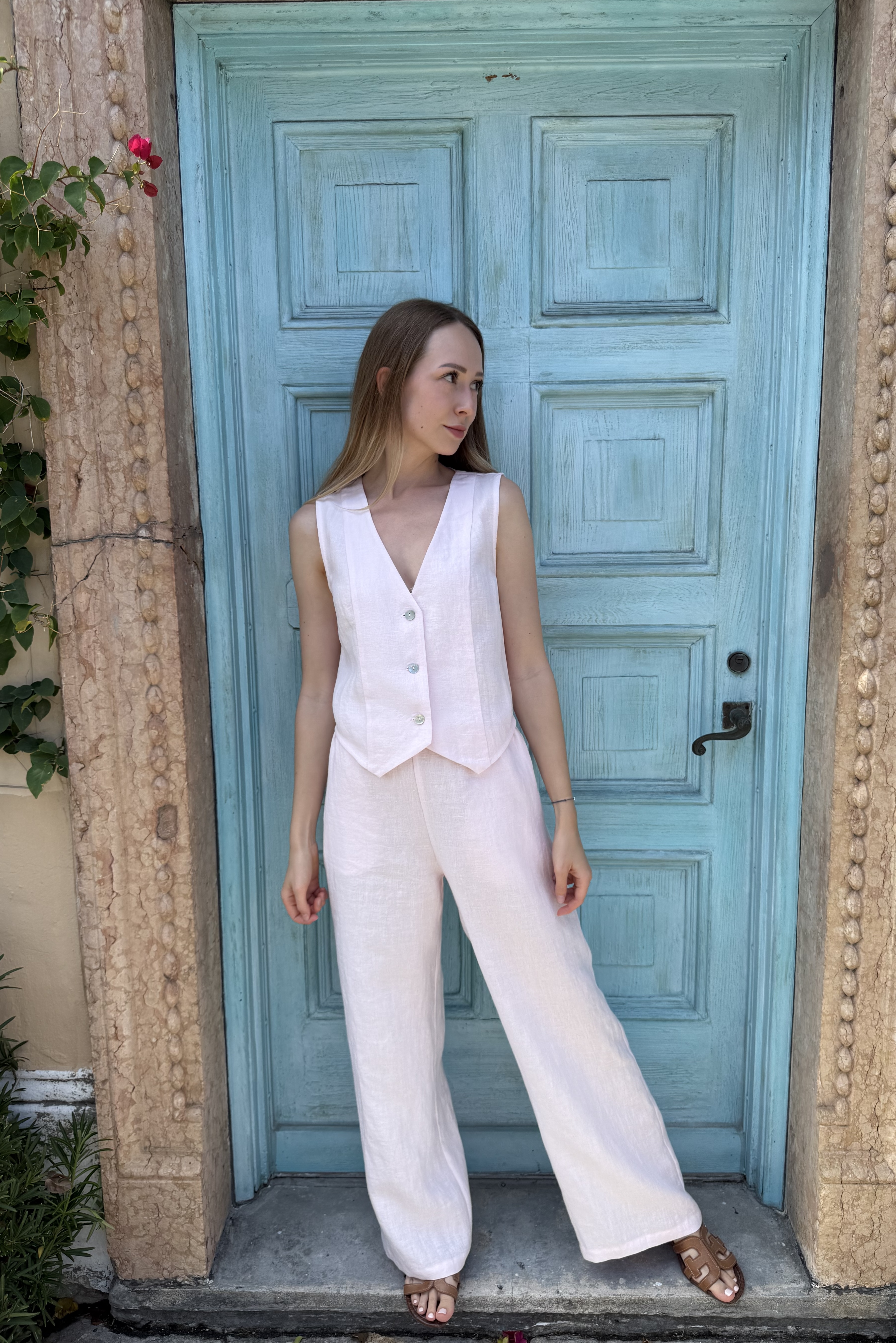 Full silhouette in front of an aqua wooden doorway